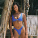 Girl on the beach wearing a blue bikini