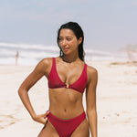 Girl on beach wearing cherry clip front bikini